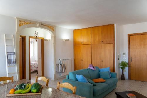 a living room with a blue couch and a table at Otranto perla d'Oriente in Otranto