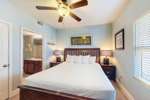 a bedroom with a bed and a ceiling fan at Laketown Wharf 1815 in Panama City Beach