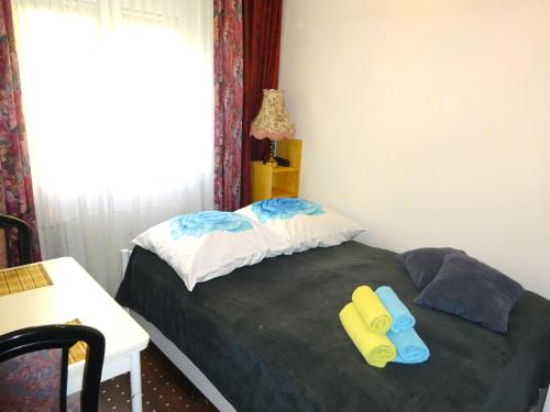 a bedroom with a bed with yellow and blue slippers at Wellem Unterkunft in Berlin West in Berlin