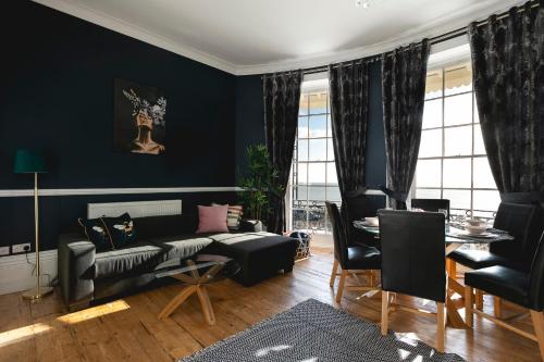 a living room with a couch and a table at Marine Parade Sea View 2-Bedroom Apartment in Brighton & Hove