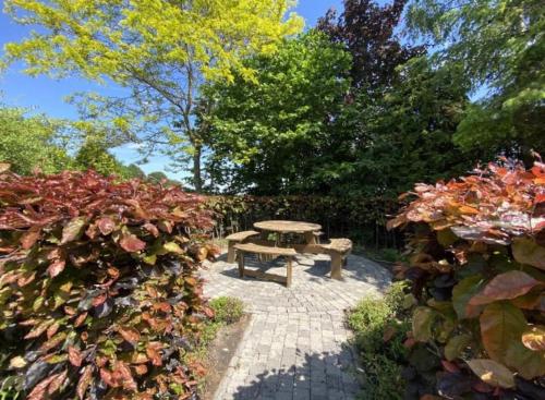 a picnic table in the middle of a garden at Sfeervol familielandhuis in de groene Kempen in Baarle-Hertog