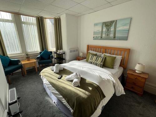 a bedroom with a large bed with towels on it at The Wilton Hotel in Blackpool