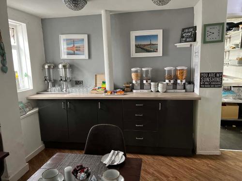 a kitchen with a counter with a counter top with a counter at The Wilton Hotel in Blackpool