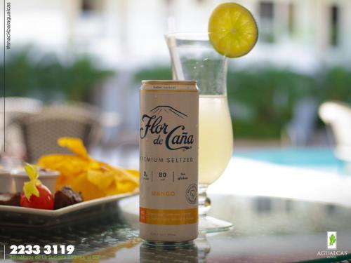 a can of chi artificial drink and a glass of orange juice at Hotel Agualcas in Managua