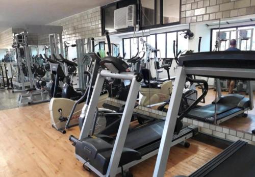 a gym with several tread machines in a room at Apartamento com toda infra e em frente a praia in Rio de Janeiro