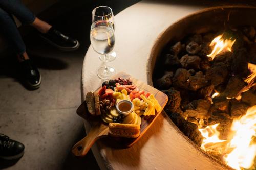 a table with a plate of food and a glass of wine at Hacienda 1800 in Cuatrociénegas de Carranza