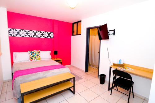 a bedroom with a bed and a desk and a tv at Hotel Casa Blanca Minero in Fresnillo de González Echeverría