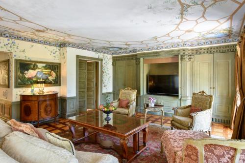 a living room with a couch and a table at The Villa Casa Casuarina in Miami Beach