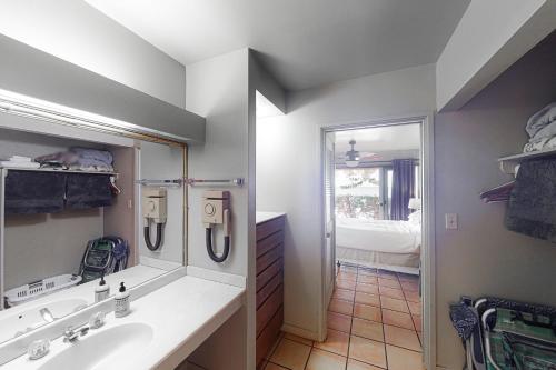 a bathroom with a sink and a mirror at Kepuhi Beach Cottage 2B in Maunaloa