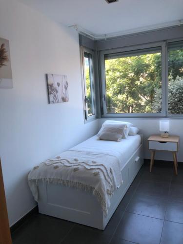 um quarto branco com uma cama e uma janela em Standing Apartment Barcelona Forum em Barcelona