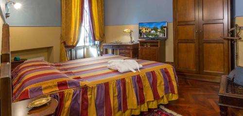 a bedroom with a bed with a towel on it at Hotel Corte dei Tini in Teramo