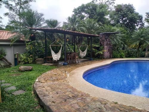 a swimming pool in a yard with a gazebo at Regenerate Wellness Center at Villas Escondidas in Grecia