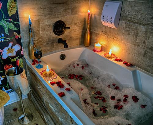 a bathtub filled with sand with candles and flowers at Bayou Chateau and Chateau Royale in New Iberia