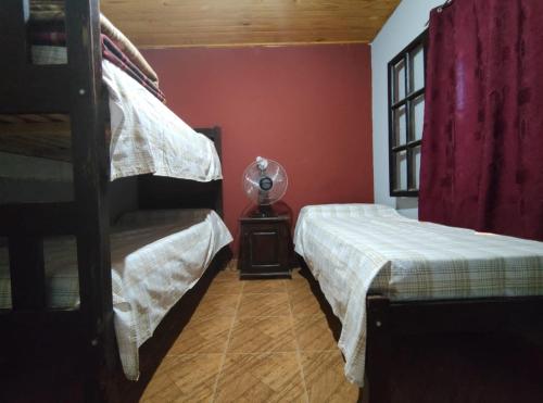 a bedroom with two bunk beds and a window at Cabañas Las Delicias in Salta