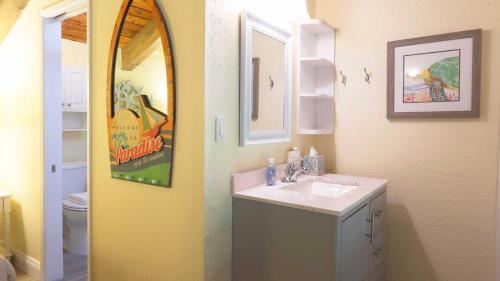 a bathroom with a sink and a mirror at Maui Westside Presents: Papakea J401 Top floor Ocean Views in Lahaina