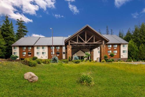 a large building with a large roof on a green field at Best Western Mt. Hood Inn in Government Camp