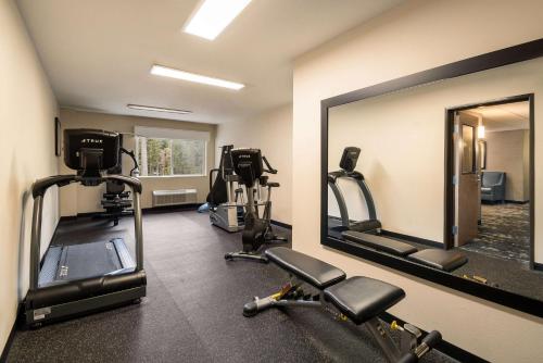 a gym with tread machines and a large mirror at Best Western Mt. Hood Inn in Government Camp