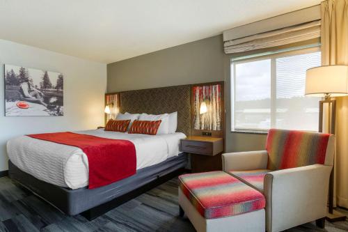 ein Hotelzimmer mit einem Bett und einem Stuhl in der Unterkunft Best Western Plus McCall Lodge and Suites in McCall