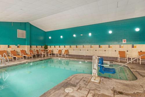 a swimming pool in a gym with chairs in it at Best Western Plus Ocean View Resort in Seaside