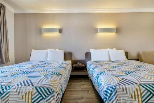 two beds sitting next to each other in a room at Motel 6-Menifee, CA in Menifee