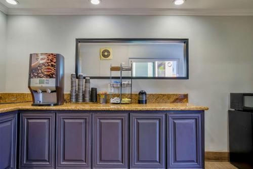 a kitchen with purple cabinets and a mirror at Motel 6-Menifee, CA in Menifee
