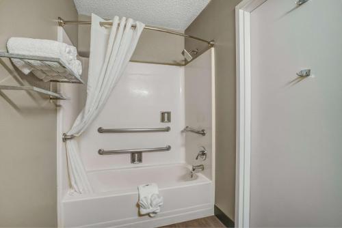 a bathroom with a bath tub with a shower curtain at Motel 6-Percival, IA in Percival