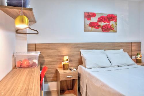 a small room with a bed and a desk with a bed sidx sidx at Flats Angatu Porto de Galinhas PE in Porto De Galinhas