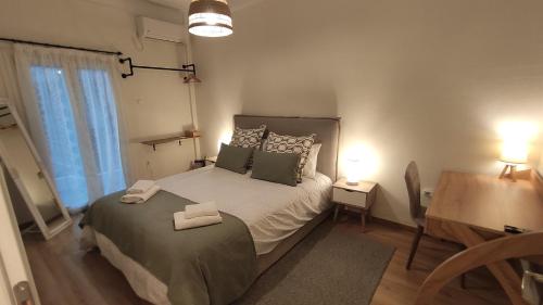 a bedroom with a bed with two boxes on it at The PM - in the heart of Thessaloniki in Thessaloniki