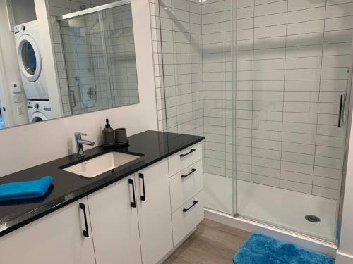 a bathroom with a sink and a shower at Joli condo en basse-ville - Parking gratuit 309357 in Quebec City