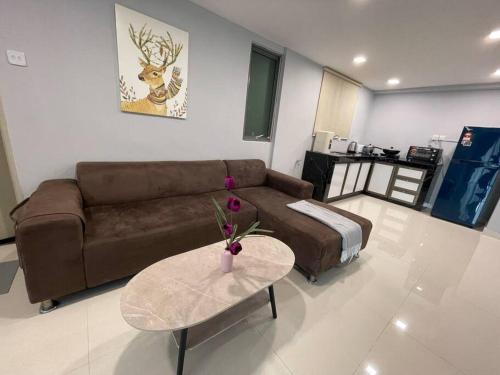 a living room with a couch and a table at Dalamanda 3Pax Sunway Velocity Balcony CItyView in Kuala Lumpur