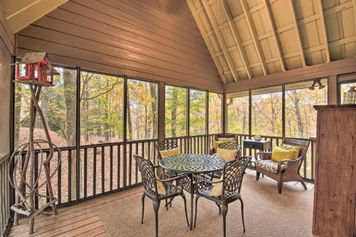 a screened in porch with a table and chairs at Big Canoe Cabin with Mountain View, Hiking and Lake! in Marblehill