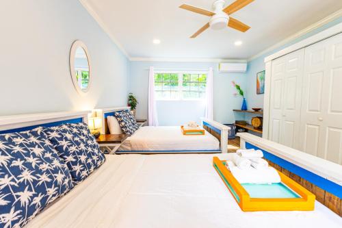 a living room with a bed and a ceiling fan at Sunset Cottage at Viking Hill in Nassau