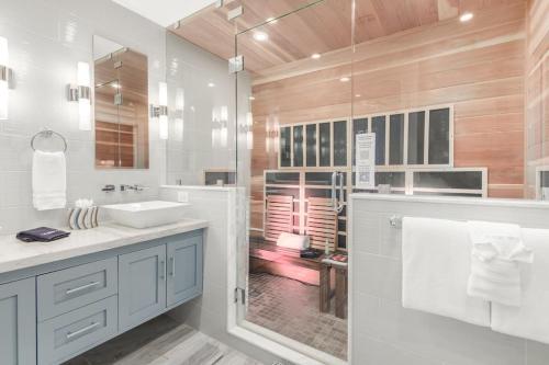 a white bathroom with a sink and a shower at Private Pool & Spa ** Steps to Old Town ** Sanatized in Scottsdale