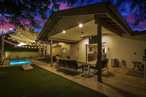 a patio with a table and chairs and a pool at Private Pool & Spa ** Steps to Old Town ** Sanatized in Scottsdale