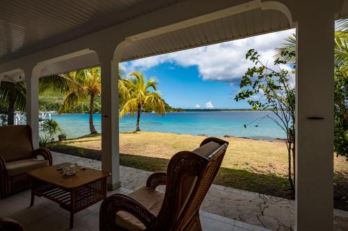 a porch with a view of the ocean at Waterfront paradise 2 br; stunning sunsets in Bora Bora