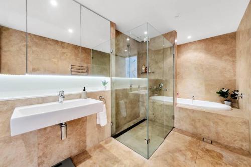 La salle de bains est pourvue d'un lavabo et d'une douche. dans l'établissement Paradise Penthouse - Beach Front Style and Luxury, à Entrance