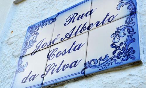 a blue and white sign on the side of a building at Casa do Arrodeio in São Mateus