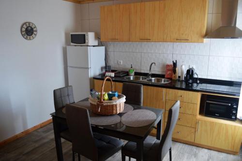 a kitchen with a table with a basket on it at Casa do Arrodeio in São Mateus