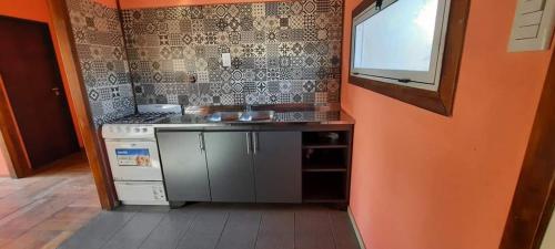 a small kitchen with a sink and a window at Brisas de Killa in General Rodríguez