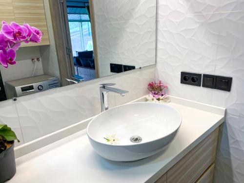a bathroom with a white bowl sink on a counter at Fare To'erau - New cozy vacation home on Bora Bora in Bora Bora