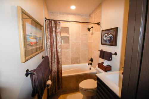 a bathroom with a tub and a toilet and a sink at Tahitian Cottage - Heated Pool Walk to the Beach in Cocoa Beach