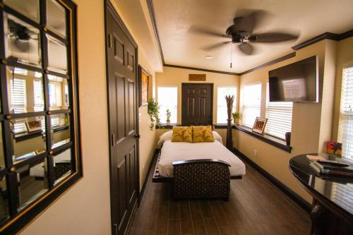 a bedroom with a bed and a ceiling fan at Tahitian Cottage - Heated Pool Walk to the Beach in Cocoa Beach