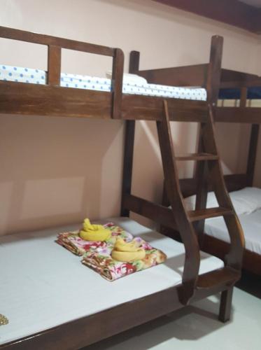 a bunk bed with a plate of bananas on the bottom bunk at D'MESA Seacretlodge and Restaurant in Taytay