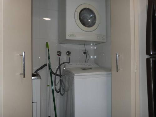 a bathroom with a sink and a washing machine at Ultra Convenient Apartment HER09029 in Sydney