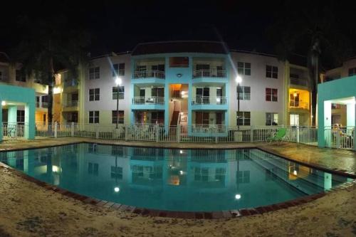 a pool in front of a building at night at Summer all year! Oceanfront with Pool A/C in Aguadilla