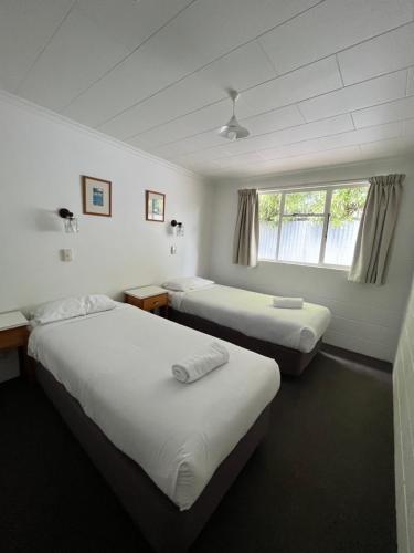a hotel room with two beds and a window at Bings Motel in Blenheim