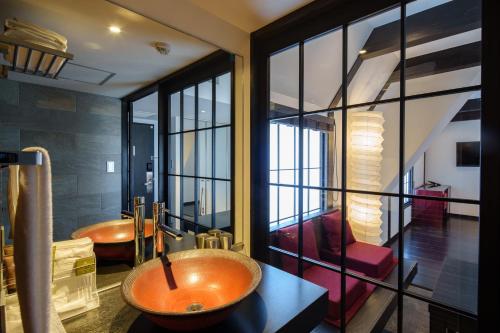 a bathroom with a sink and a tub in a room at Shibuya Hotel En in Tokyo