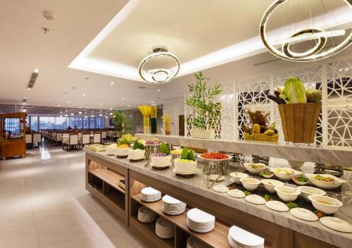 a buffet line with plates and bowls of food at Libra Hotel Nha Trang in Nha Trang