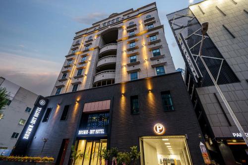 a building with a sign on the front of it at Browndot Hotel Sangmu in Gwangju