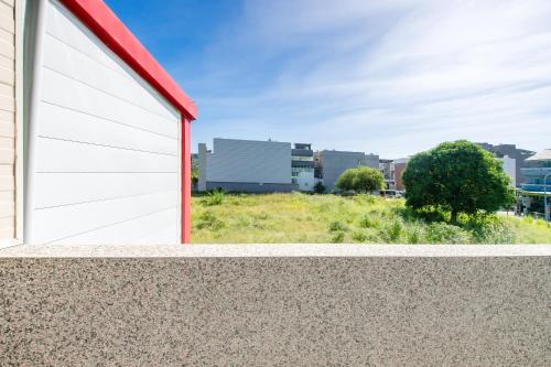 a white and red garage door on a building at Taitung Yu Krung Smart Stay in Taitung City